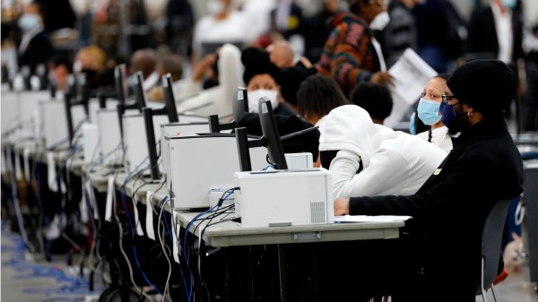 2020年11月4日，美国密歇根州底特律TCF中心内工作人员在计算缺席选票。（图片来源：JEFF KOWALSKY/AFP via Getty Images）