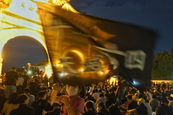 六四天安门事件31周年，“遍地烛光悼六四”活动4日晚间在台北自由广场举行，现场有民众挥舞旗帜表达诉求。