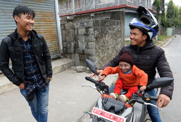 2018年12月8日，世界最矮的人马加尔Khagendra Thapa Magar坐在他的弟弟的摩托车上。
