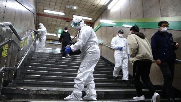 中共肺炎病毒能夠存活在物體表面多久？是大家一直相當關注的問題。圖為戴著防護裝備的消毒人員在首爾地鐵站噴灑消毒劑。