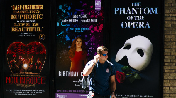 美国百老汇联盟宣布将取消今年下半年纽约市的所有百老汇演出。图为一名男子走过纽约曼哈顿的剧院区。（图片来源：Eduardo Munoz Alvarez/Getty Images）