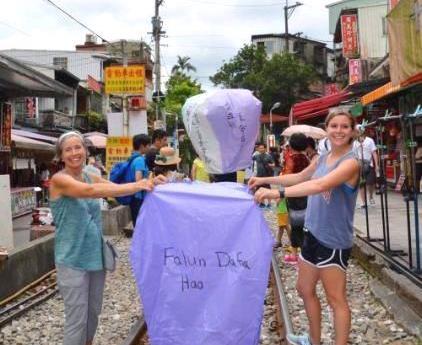 珍妮﹒米切爾（左）在台灣平溪燃放寫著「法輪大法好」的天燈。