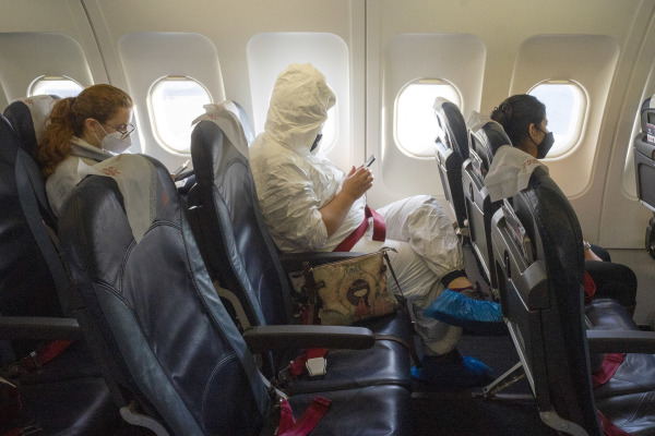 飛機上戴著口罩的乘客