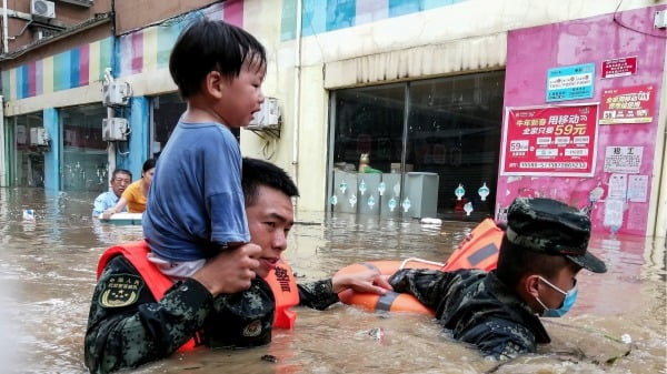 8月12日，中国湖北省随州市遭遇洪灾后，救援人员正在疏散一名儿童。